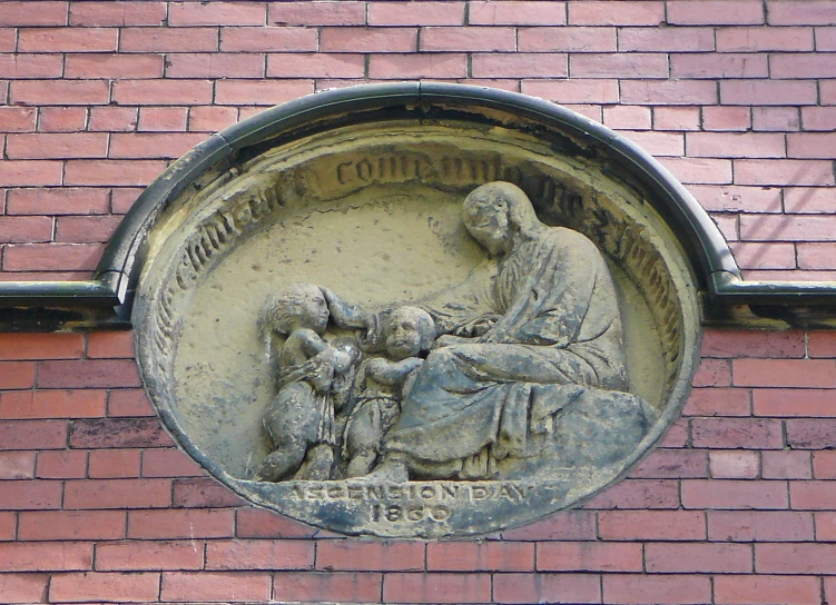 a brick building with a plaque depicting an old man sitting in a corner