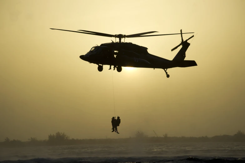 a person jumping from a helicopter in the air