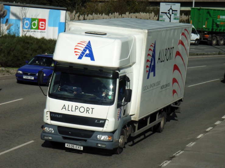 a truck is driving down the road near other vehicles