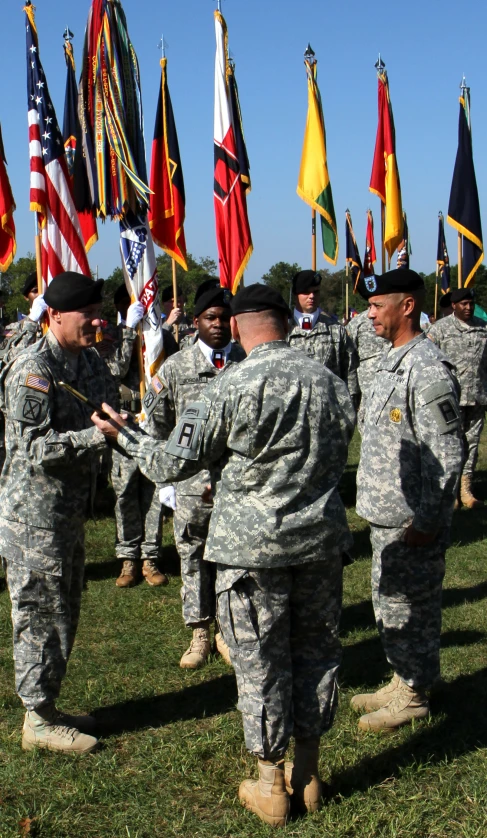 a group of military personnel standing in a line next to each other