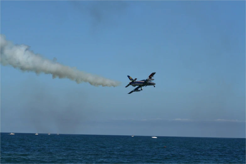 an airplane is flying low over the water