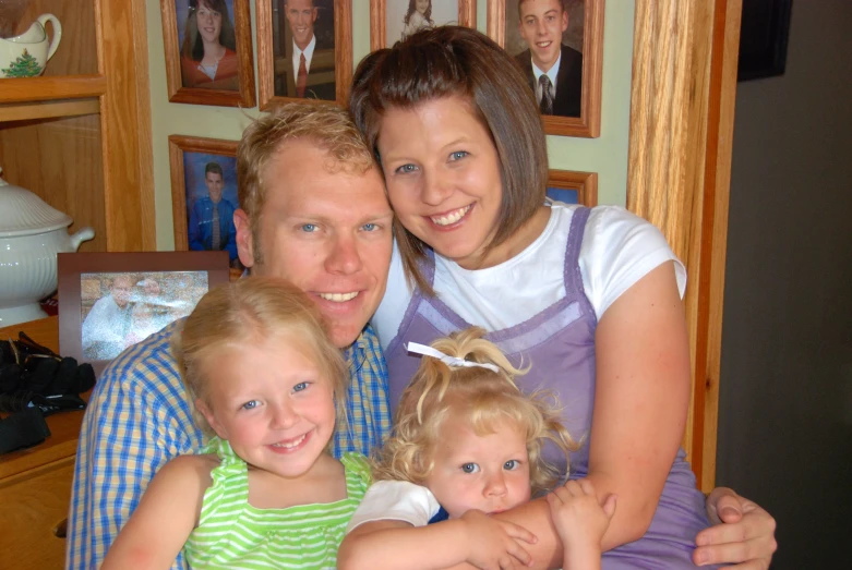 a family smiling together sitting in the living room