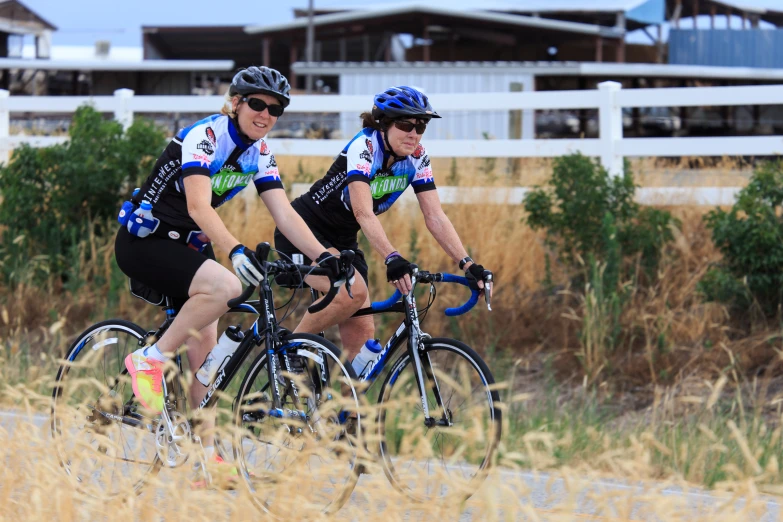 two people on bicycles ride side by side