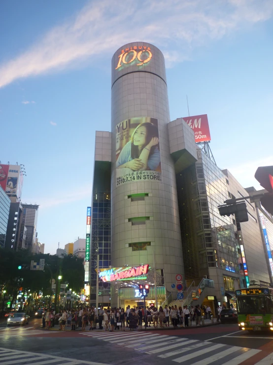 a large building with people on it near a cross walk