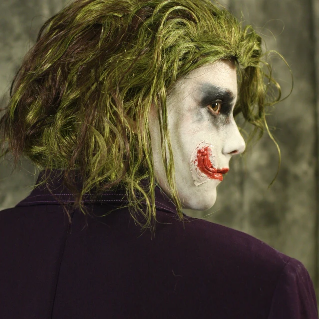 the young man with crazy hair is dressed up as joker