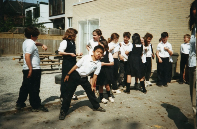 a school choir standing around next to a building