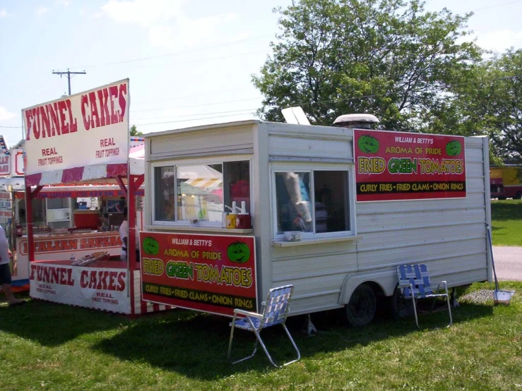 the food truck is displaying signs for people to order