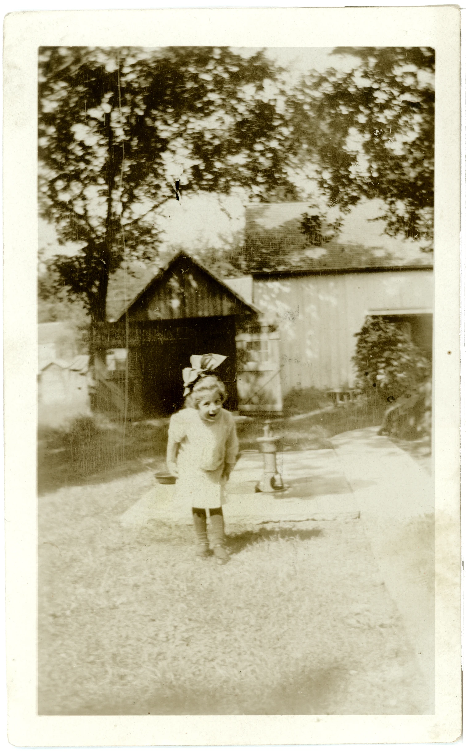 an old fashioned po of a girl with a hat