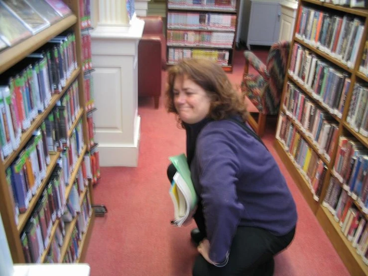 an old woman carrying books in a liry