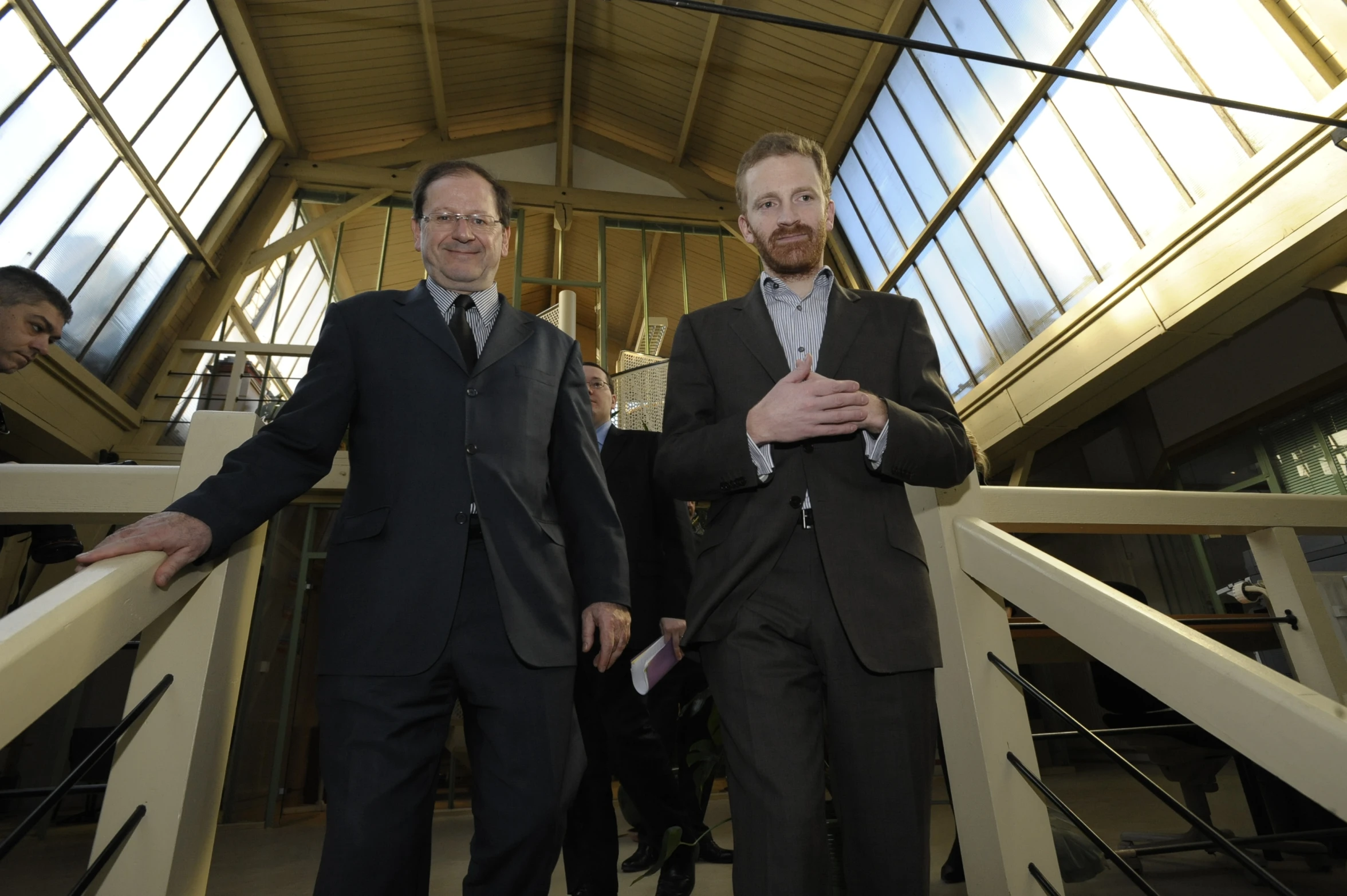 two men in suits posing for the camera