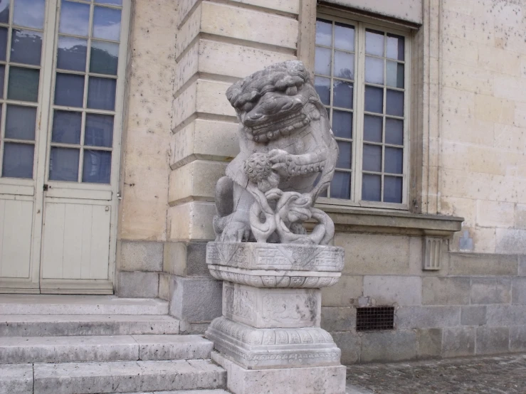 a stone sculpture in front of a building