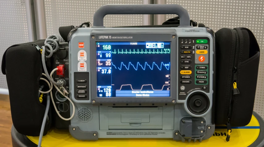 a medical unit with headphones on and a large monitor