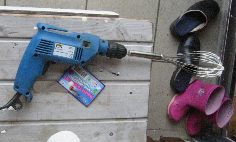 an image of an electric nailgung on a wooden block