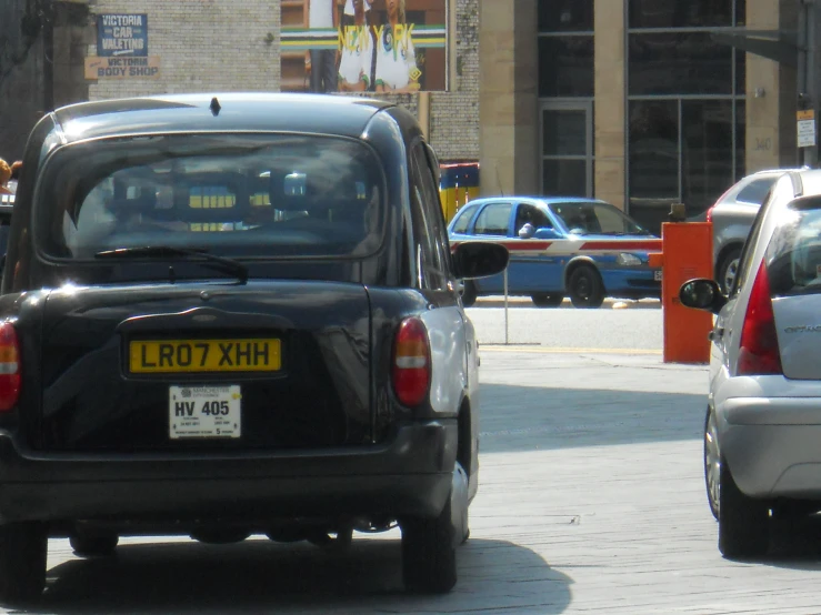 a black vehicle is driving on the road