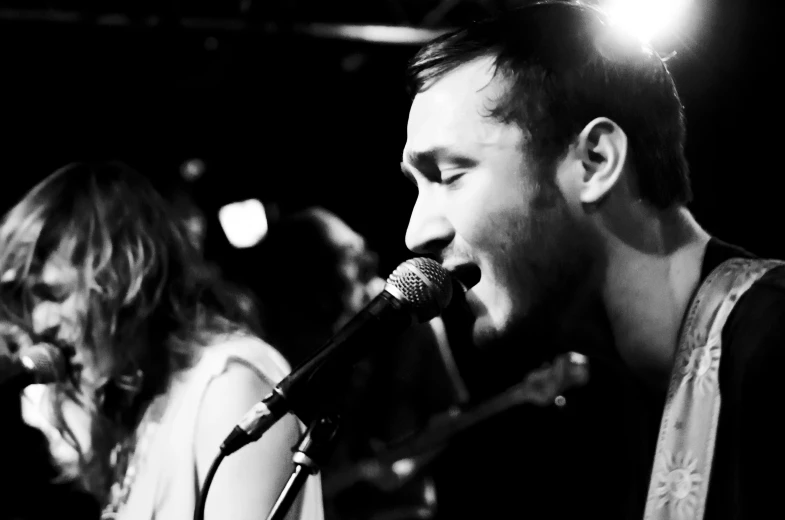 two people playing music on a stage