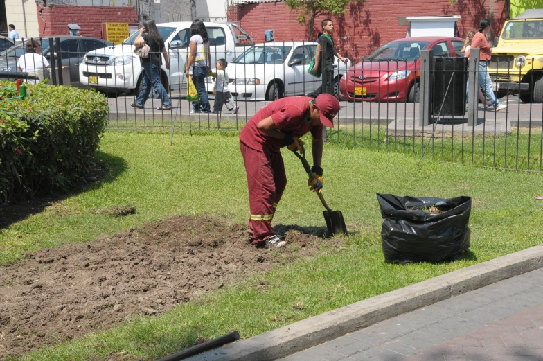 a man digging in a field, his hands are on the ground