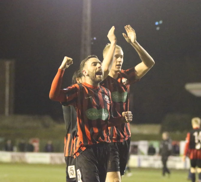 a soccer player has his hands in the air