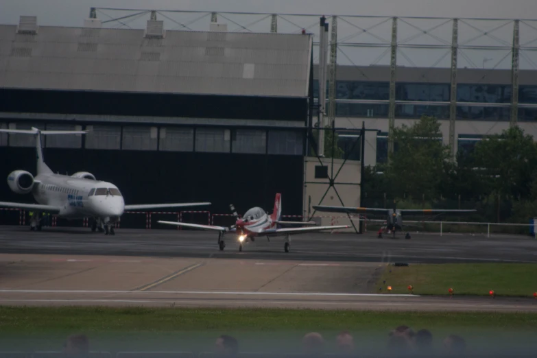 two airplanes are parked in the small airport