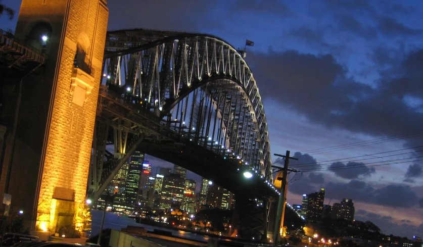 a city with a bridge in front of it at night