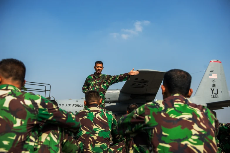 a military man is looking at the airplane