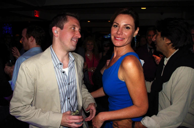 a man and a woman laughing together at a party