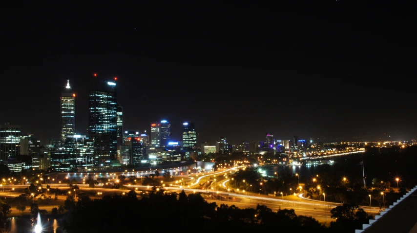 a night time view of some skyscrs with traffic lights