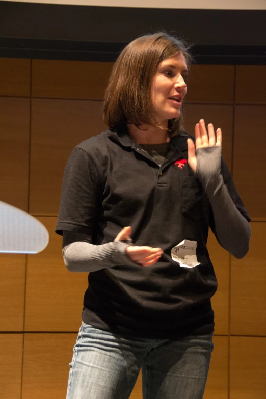 a woman is standing with a projector in her hand