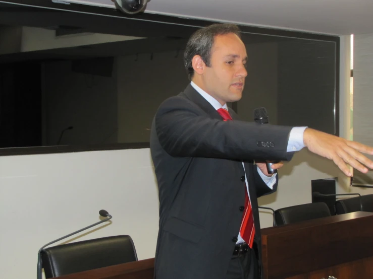 man holding soing out with his hand while giving presentation