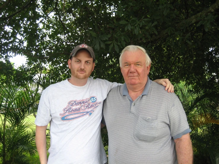 an old man and a young man under the tree