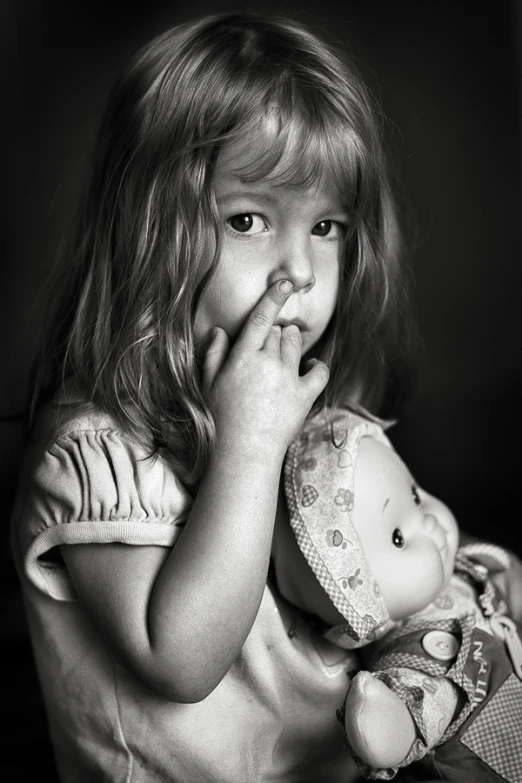 a little girl in a dress holding her hands together