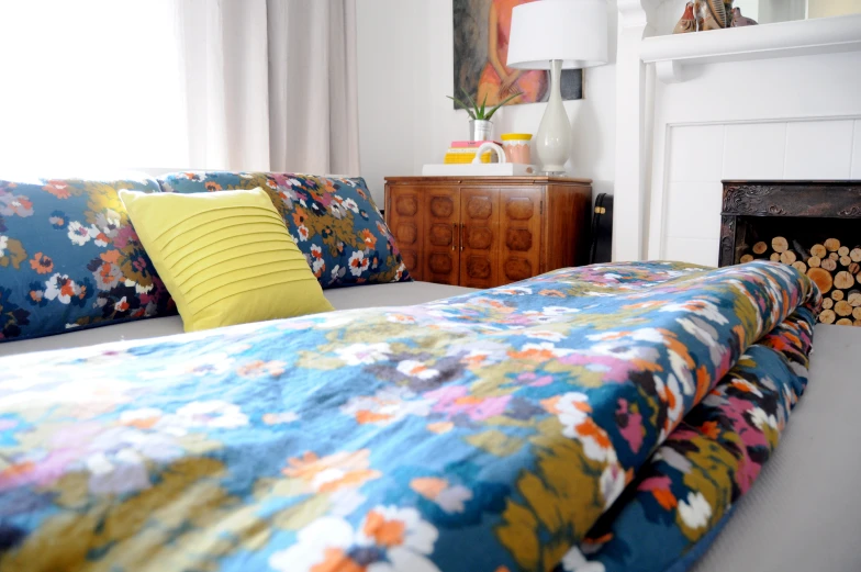 a neatly made bed with colorful sheets and pillows