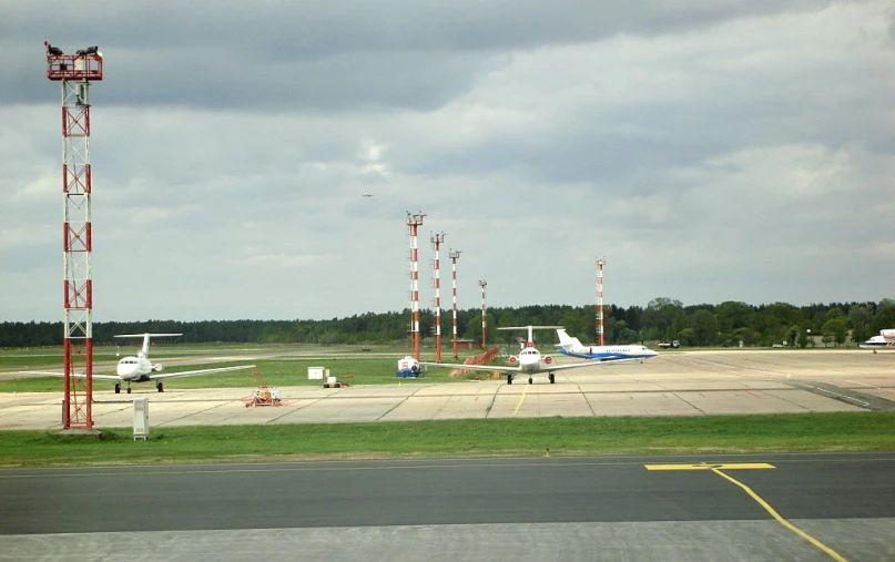 several planes sitting on a runway at an airport
