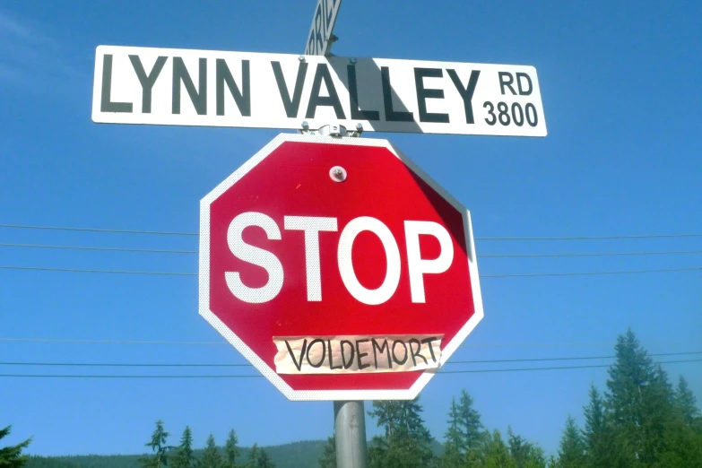 there is a red stop sign under the street signs