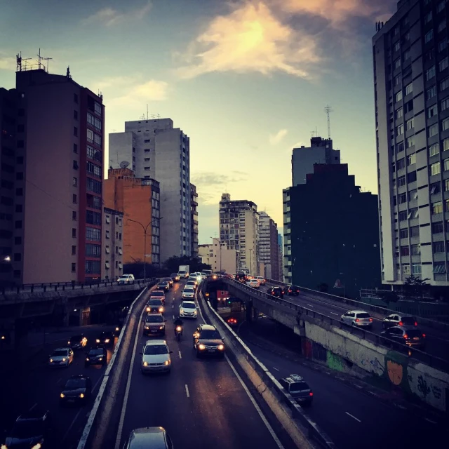 a busy street filled with traffic with buildings and towers