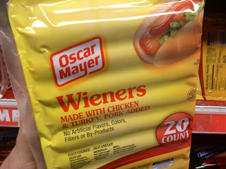 someone holding a pack of wieners made with chicken