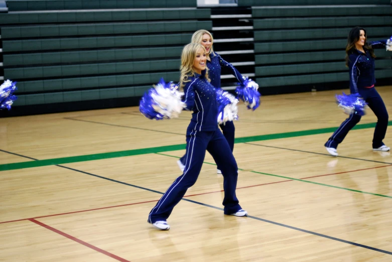 a group of women perform at a basketball game