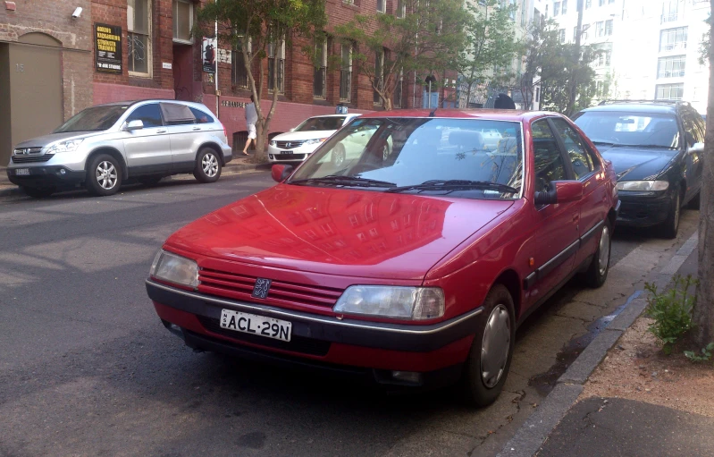 two cars parked near the side of a road