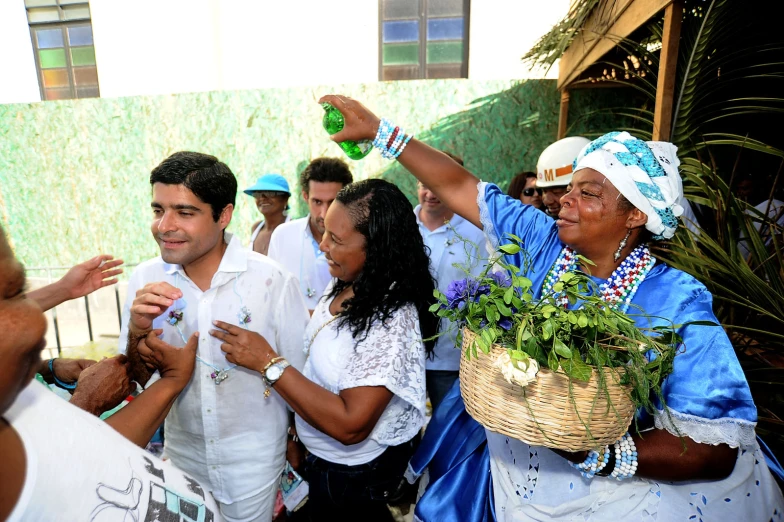 several people holding plants and giving thumbs up