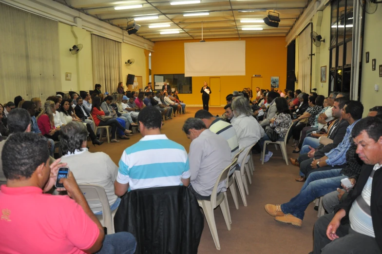 a man giving a speech in front of a crowd