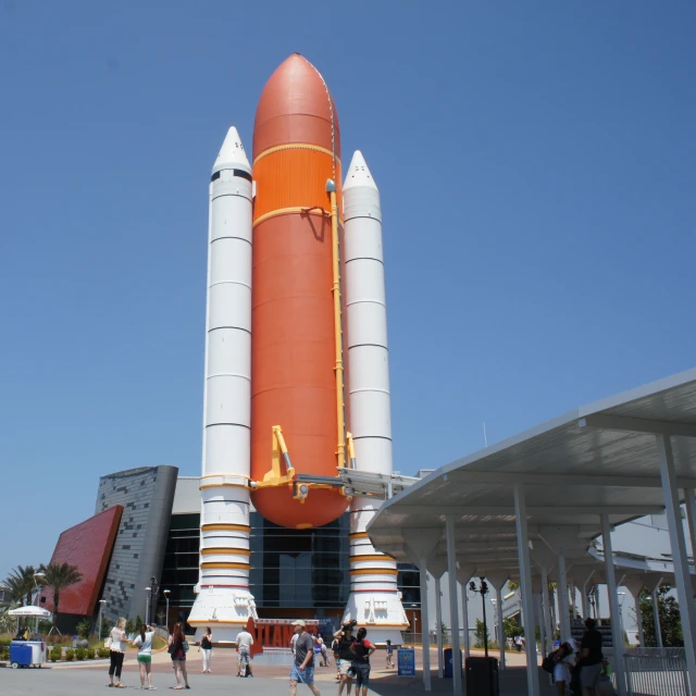 the giant rocket ship is next to the parking lot