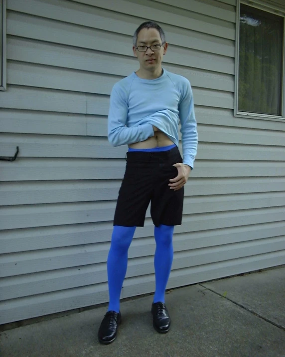 a person with black shorts wearing blue socks