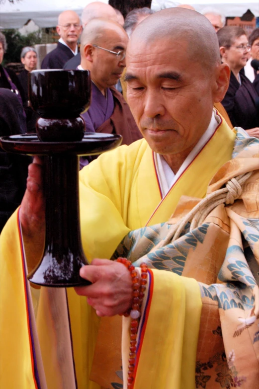 a man holding a candle near a priest