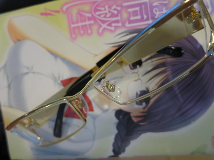 some anime glasses on a picture frame with a background