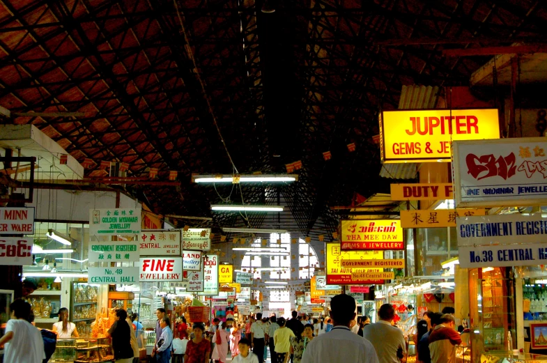 many people are walking around at a market