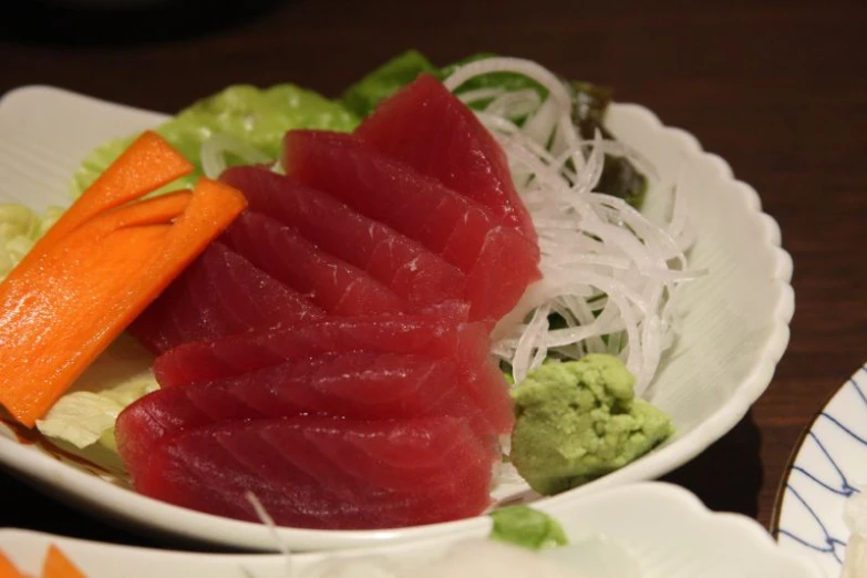 large bowl of sushi and some noodles with vegetables