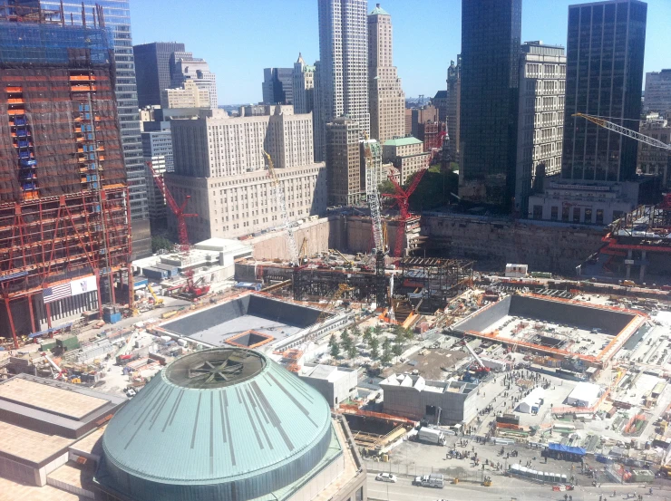 an urban skyline with skyscrs covered in scaffolding