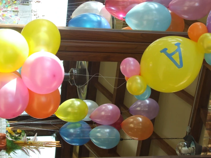 a large bunch of balloons with a cross symbol on them