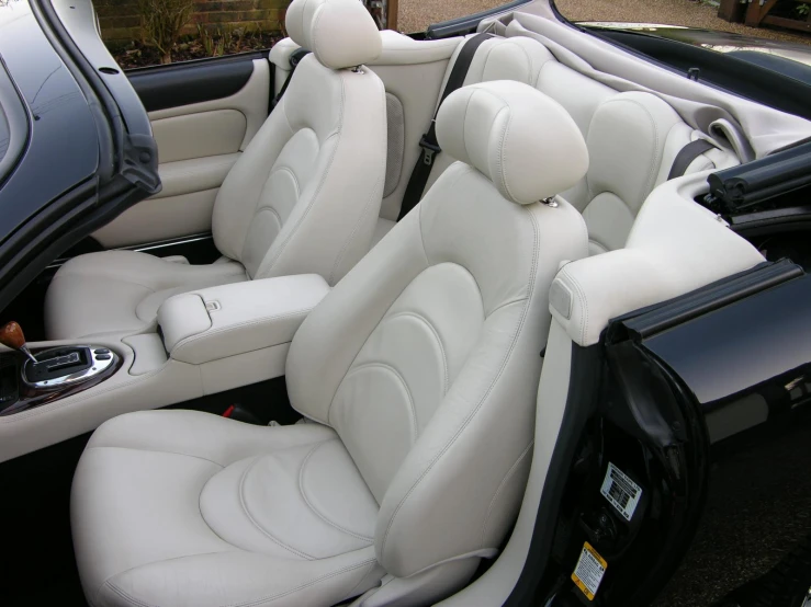 a car has white leather interior and seats