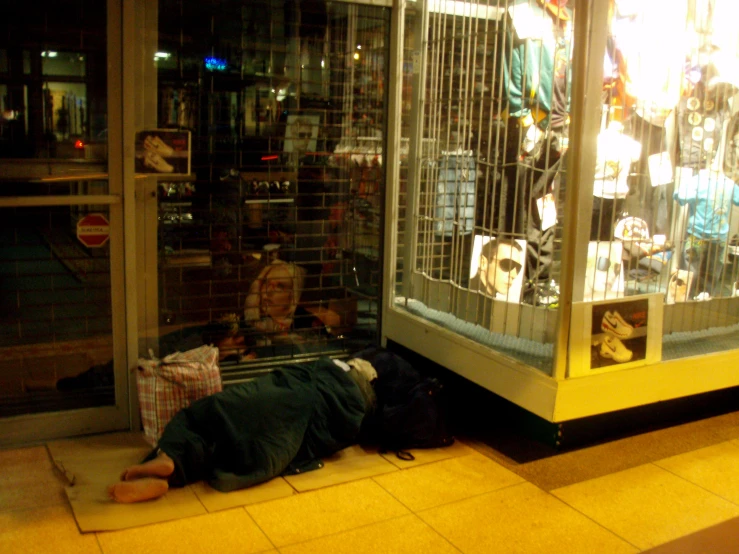 a man laying on the floor by a store display