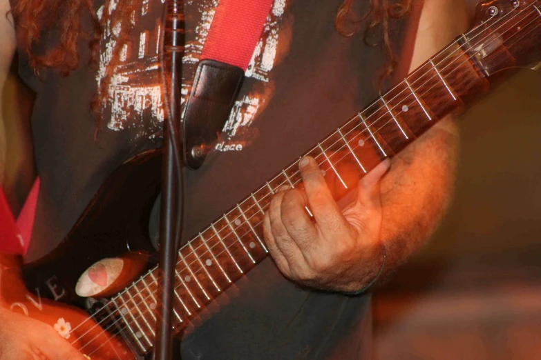 a person playing a guitar on stage at a concert